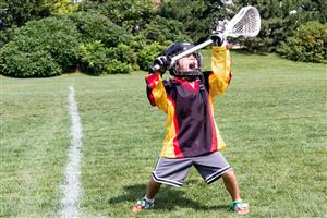 Youth lacrosse player catching ball