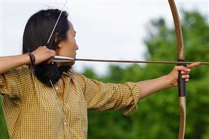 Woman aiming arrow on bow
